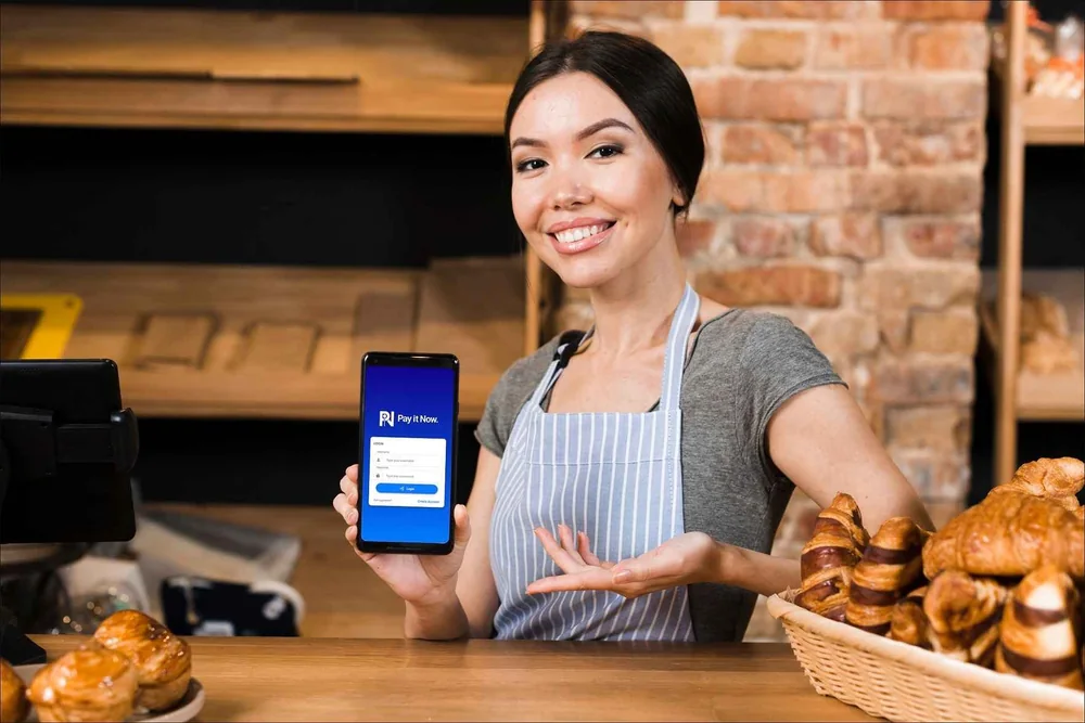 A bakery customer paying with their phone