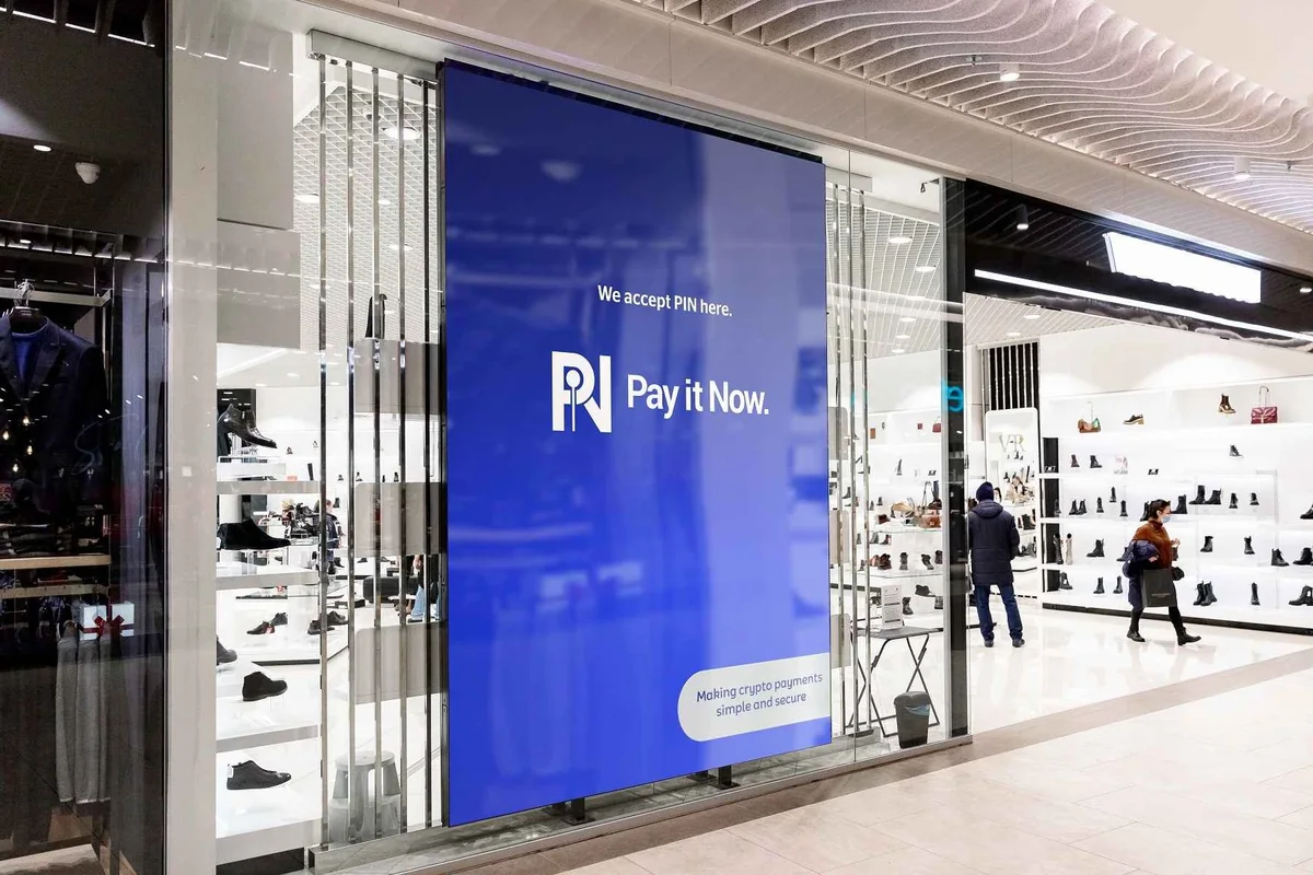 A shop front advertising that crypto is accepted